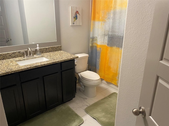 full bath featuring marble finish floor, toilet, and vanity