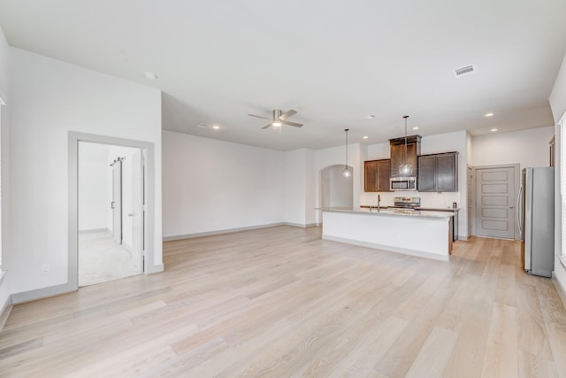 11913 Mockingbird Ln, Montgomery, TX 77356 - unfurnished living room with a sink, ceiling fan, light wood-style floors, recessed lighting, and baseboards
