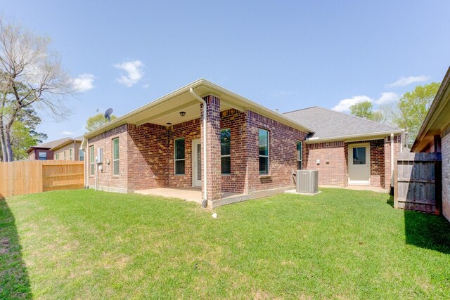 11913 Mockingbird Ln, Montgomery, TX 77356 - rear view of house featuring brick siding, cooling unit, and a patio area
