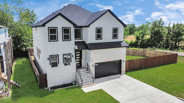 view of front of home with a front yard and a garage