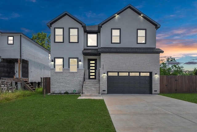 view of front of property with a yard and a garage