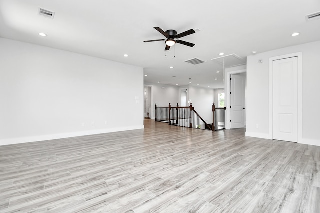 spare room featuring light wood-type flooring and ceiling fan