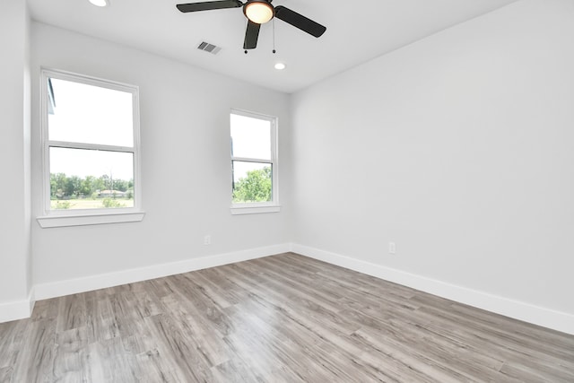 spare room featuring ceiling fan and light hardwood / wood-style flooring