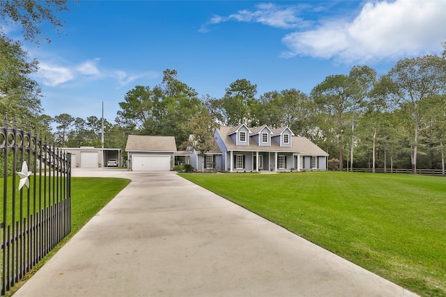 cape cod home featuring a front yard and a garage