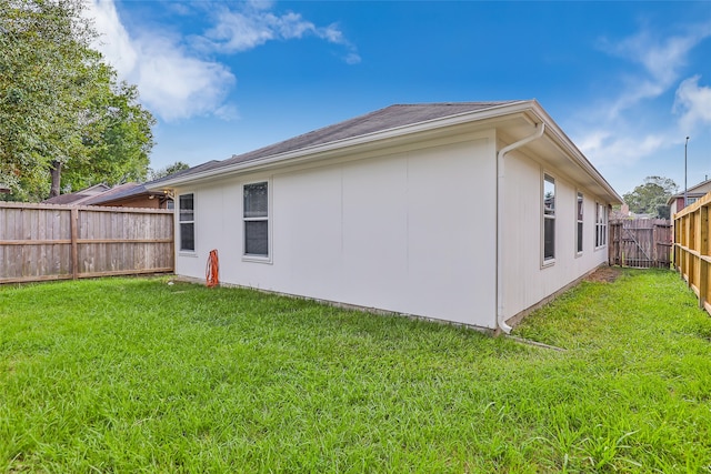 back of property with a lawn