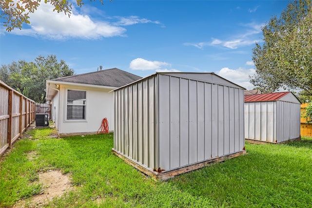 view of outbuilding featuring a yard and cooling unit