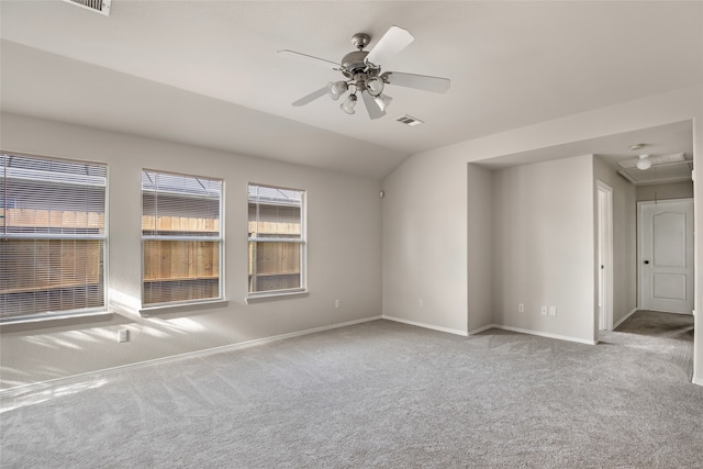 carpeted empty room with ceiling fan and vaulted ceiling