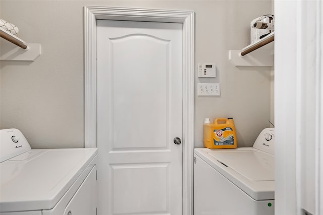 laundry room with washing machine and clothes dryer