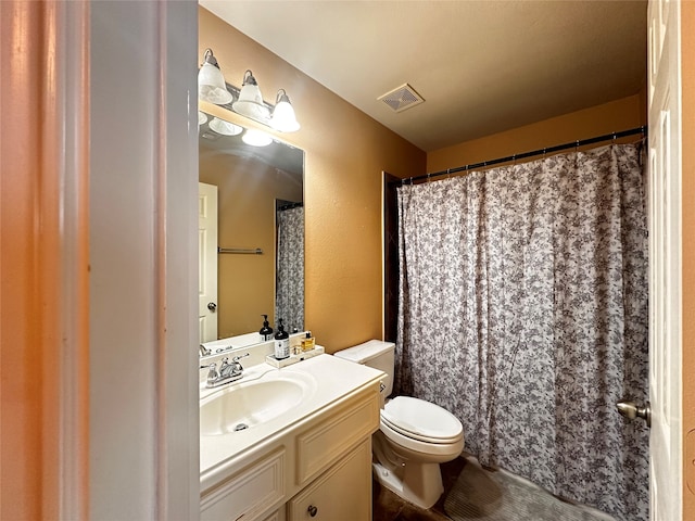 bathroom with vanity, toilet, and curtained shower