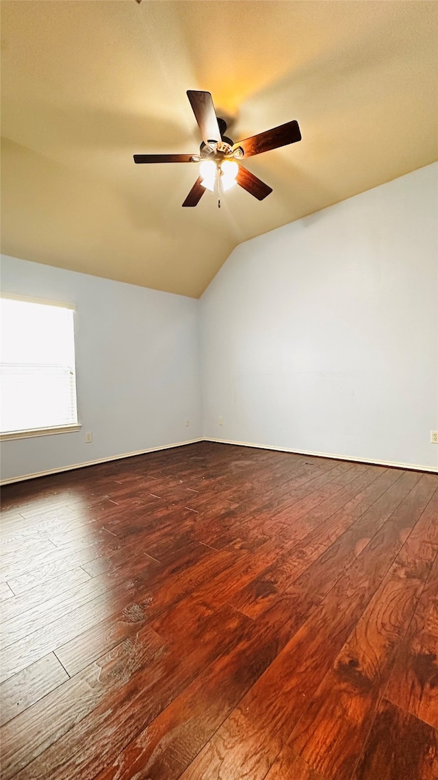 empty room featuring ceiling fan, wood-type flooring, and vaulted ceiling