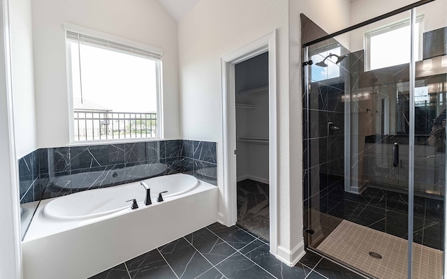 bathroom with lofted ceiling, a wealth of natural light, and separate shower and tub