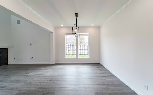 unfurnished dining area featuring crown molding and wood-type flooring