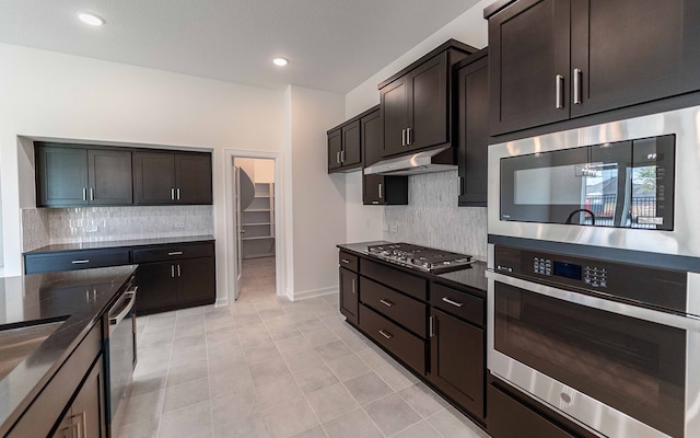 kitchen featuring backsplash, appliances with stainless steel finishes, dark brown cabinetry, and light tile patterned floors