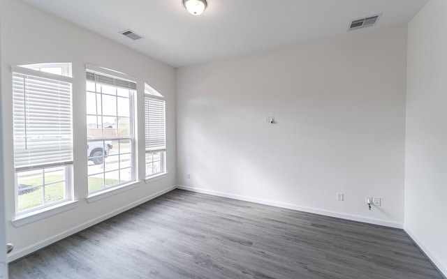 empty room featuring dark hardwood / wood-style flooring