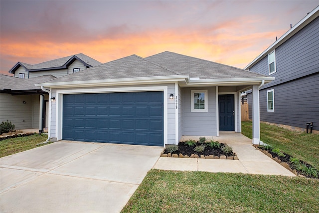 view of front facade with a garage and a yard