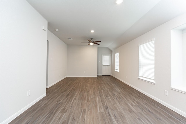 empty room with dark hardwood / wood-style floors, ceiling fan, and lofted ceiling