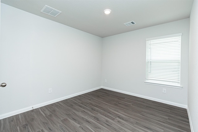 empty room featuring dark hardwood / wood-style flooring