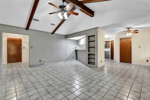 tiled spare room featuring wood walls, lofted ceiling with beams, and ceiling fan