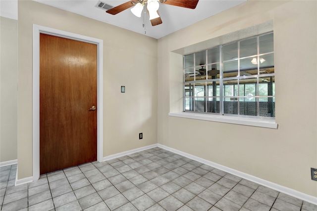 unfurnished room with light tile patterned floors and ceiling fan