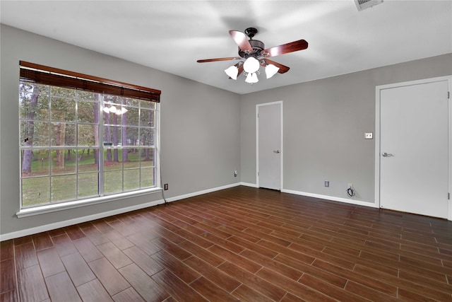 spare room featuring ceiling fan and dark wood-type flooring