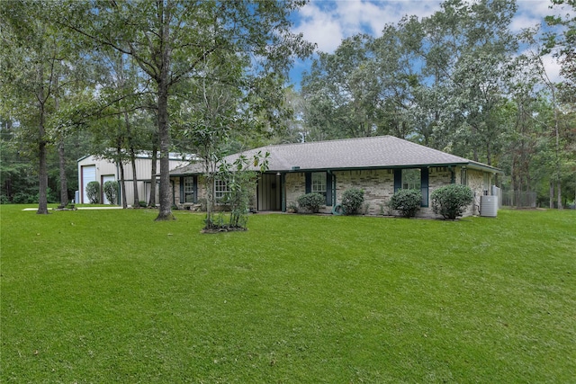 view of front facade with cooling unit and a front lawn