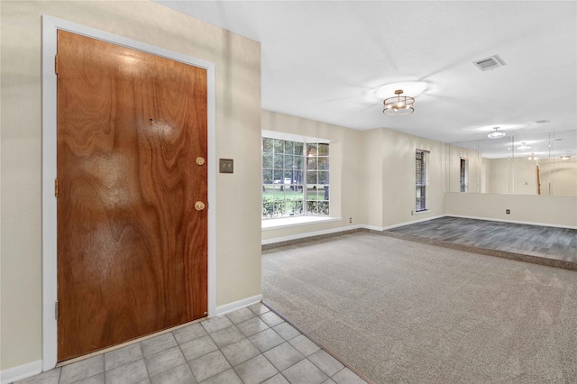 entryway featuring light colored carpet