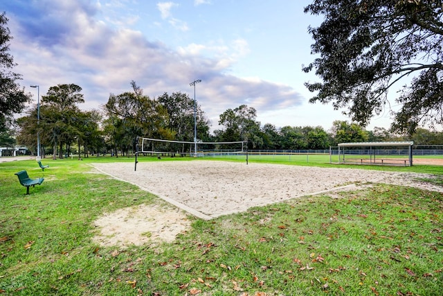 view of home's community with volleyball court and a lawn