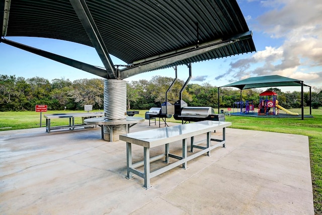 view of home's community with a playground, a patio area, and a lawn