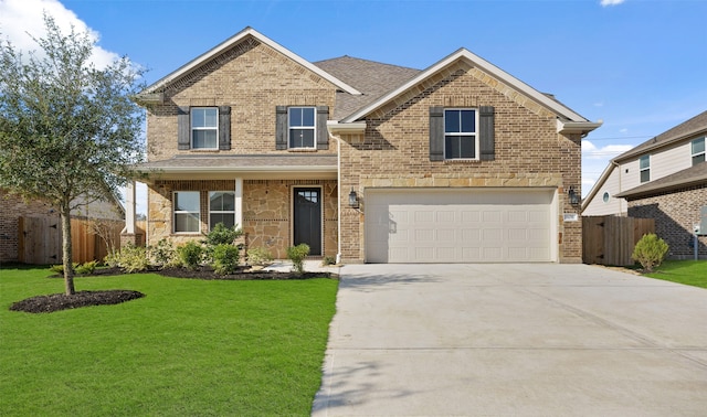 view of front of home featuring a front yard and a garage