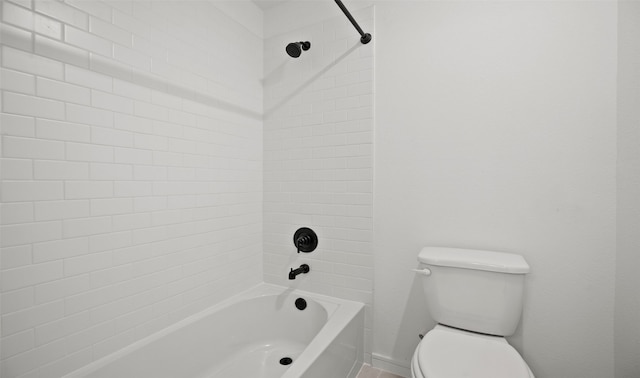 bathroom featuring tiled shower / bath and toilet