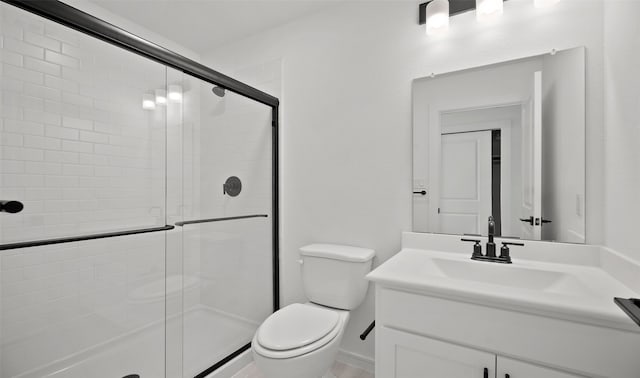 bathroom featuring vanity, an enclosed shower, and toilet