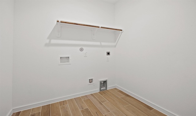 laundry area featuring wood-type flooring, hookup for a washing machine, gas dryer hookup, and electric dryer hookup