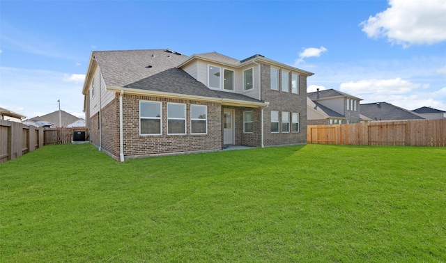 rear view of property featuring a yard