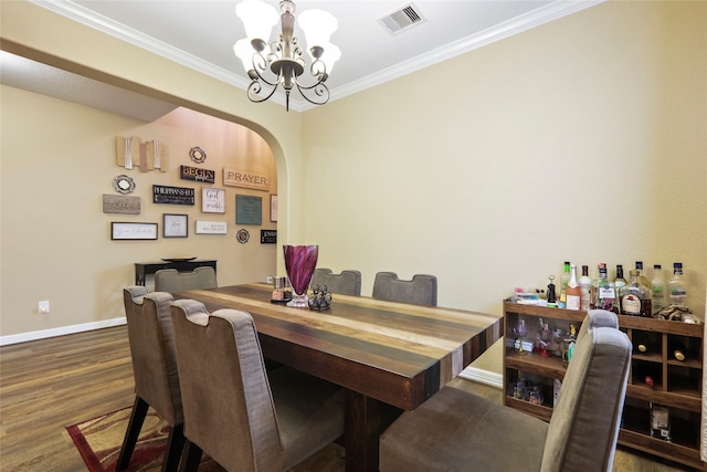 office with a chandelier, bar area, dark wood-type flooring, and crown molding