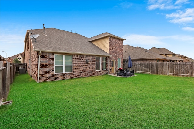 rear view of property with a patio, a yard, and central AC unit