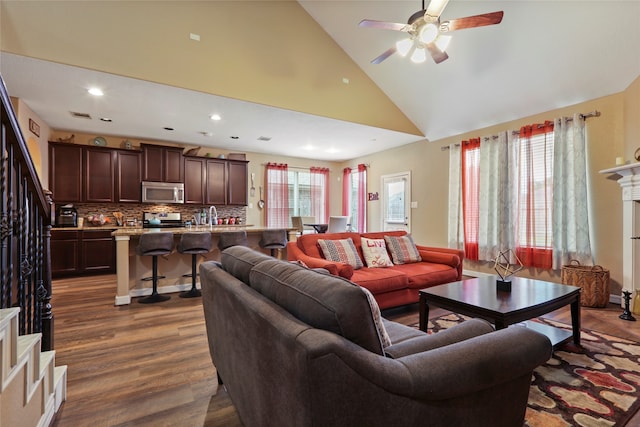 living room featuring high vaulted ceiling, ceiling fan, plenty of natural light, and hardwood / wood-style floors