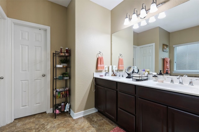 13423 Astley Acres Ln, Cypress, TX 77429 - bathroom with baseboards, a sink, and double vanity