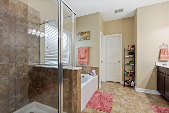 bathroom with tile patterned flooring, vanity, and plus walk in shower