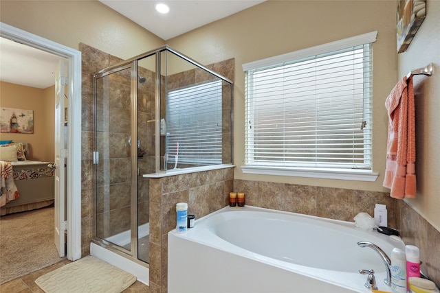 bathroom with tile patterned flooring and independent shower and bath