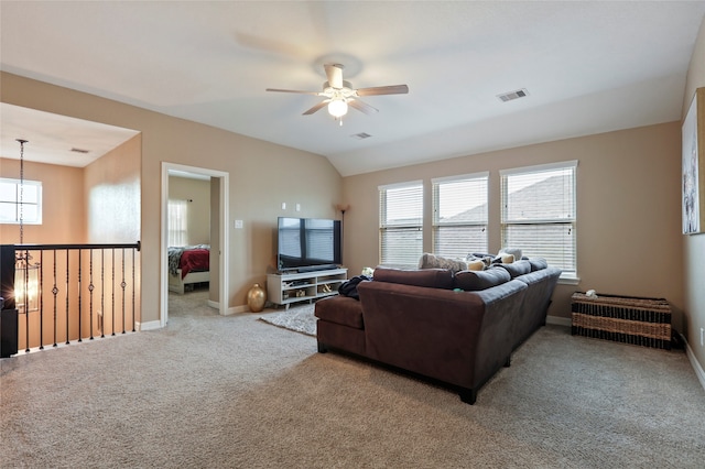 carpeted living room with ceiling fan and lofted ceiling