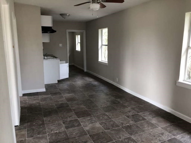 kitchen featuring white cabinets, plenty of natural light, and ceiling fan