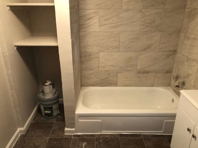 bathroom with vanity and a bath