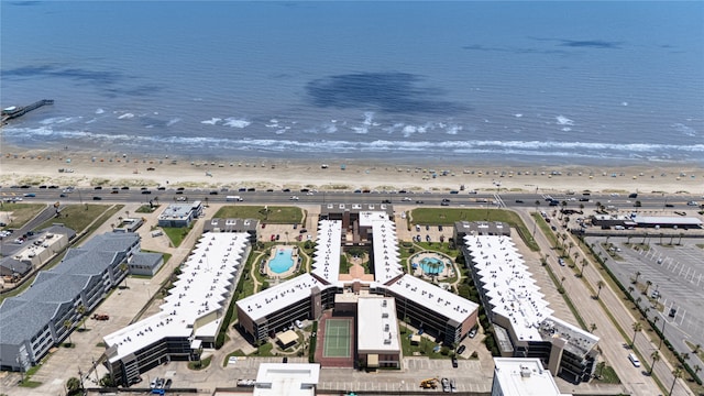 drone / aerial view with a water view and a beach view