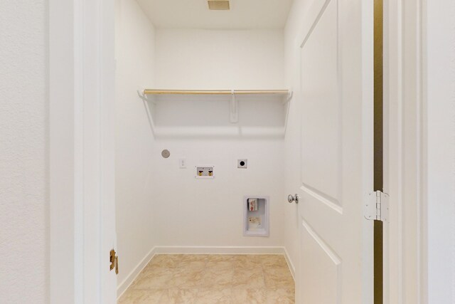 clothes washing area with hookup for a washing machine, gas dryer hookup, and electric dryer hookup