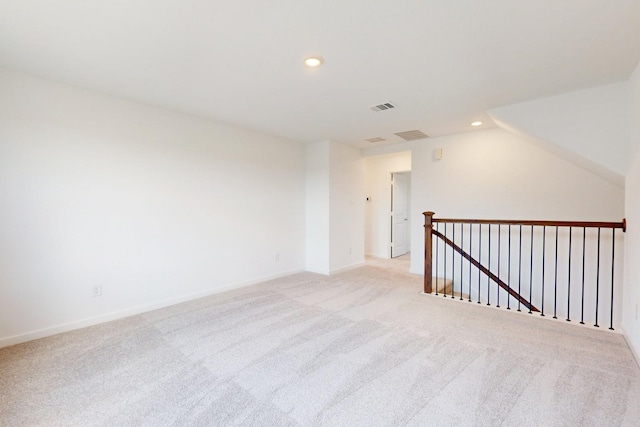 unfurnished room with recessed lighting, visible vents, light carpet, and baseboards