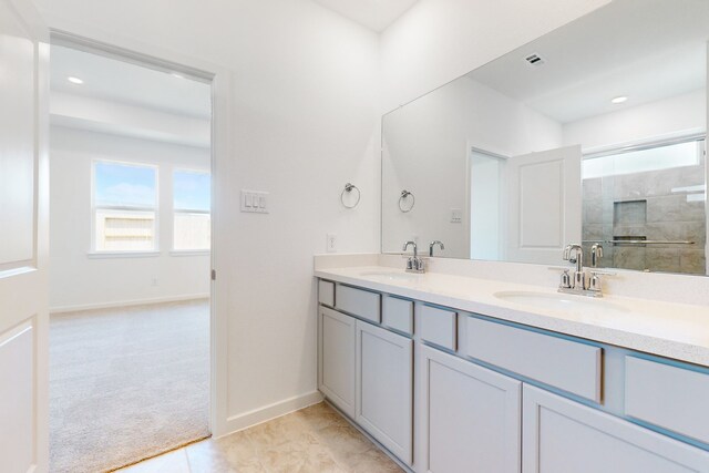 bathroom with an enclosed shower and vanity