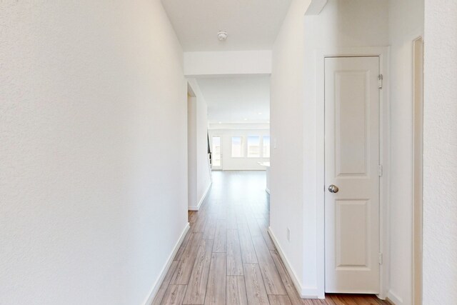 hallway with light wood-type flooring