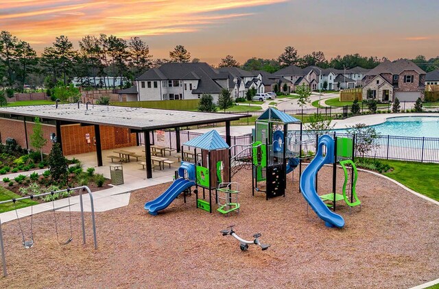 playground at dusk with a community pool