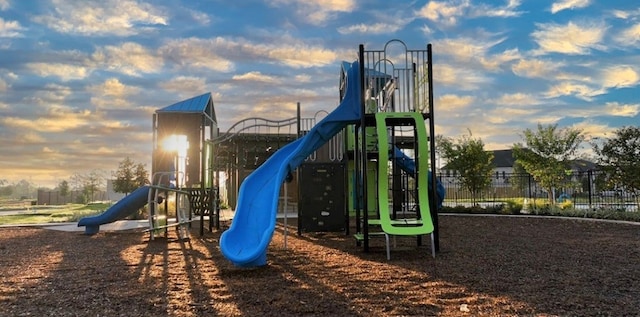 playground at dusk featuring fence and playground community