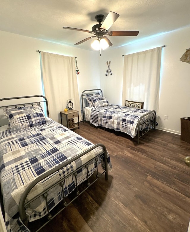 bedroom featuring ceiling fan and dark wood-type flooring